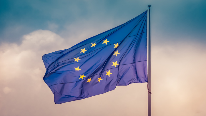 EU flag on blue and pink sky background