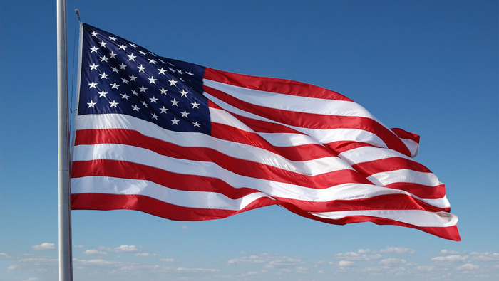 US flag in blue sky background