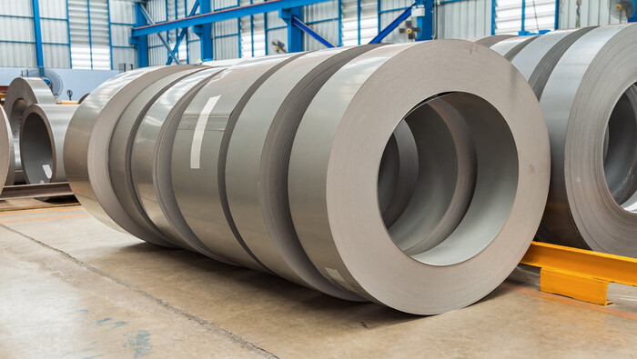 Rolls of steel silicon sheets in a warehouse